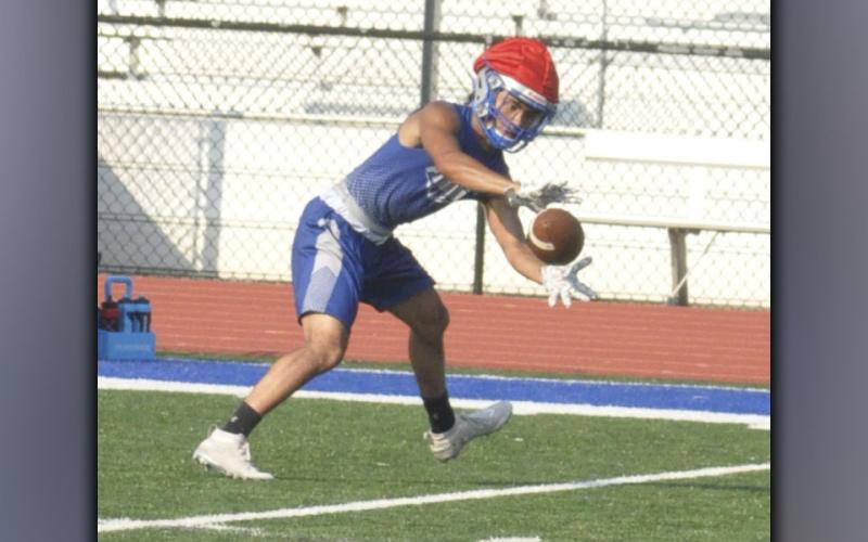 Austin Garland snags a pass during the Rebels football practice Thursday, July 29.