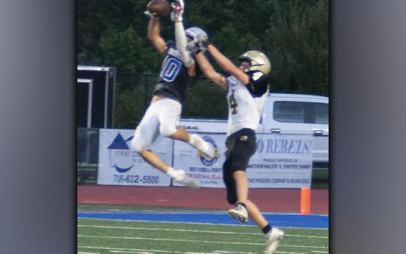 Carter Mann (10) shows his hops by snagging a pass during the Rebels scrimmage with the Hayesville Yellow Jackets Friday, August 13.