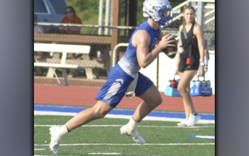 Seth Reece rolls out and looks for the open man during the Rebels football practice Thursday, July 29. Reece will play multiple positions this fall.