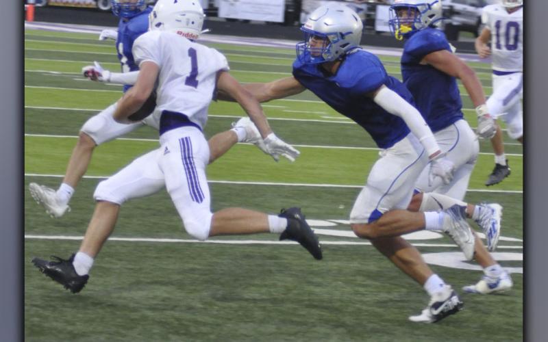 Hayden Lynch (middle) and Cason Owenby (far right) chase down a Gilmer County ball carrier during the Rebels and Bobcats’ preseason scrimmage Friday, August 6. Lynch and Owensby had a great game on both sides of the ball.