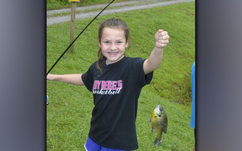 Lynnex Patterson smiles as she shows off her nice Bluegill she caught at Fannin County Recreation Department’s fishing camp Wednesday, July 28. Patterson caught over 10 fish that day.