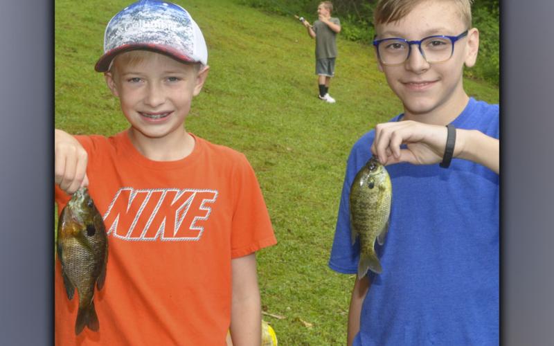 Jacob Curtis, left, and Jonathan Jones caught two Bluegill at the same time during the Fannin County Recreation Department’s fishing camp Wednesday, July 28.