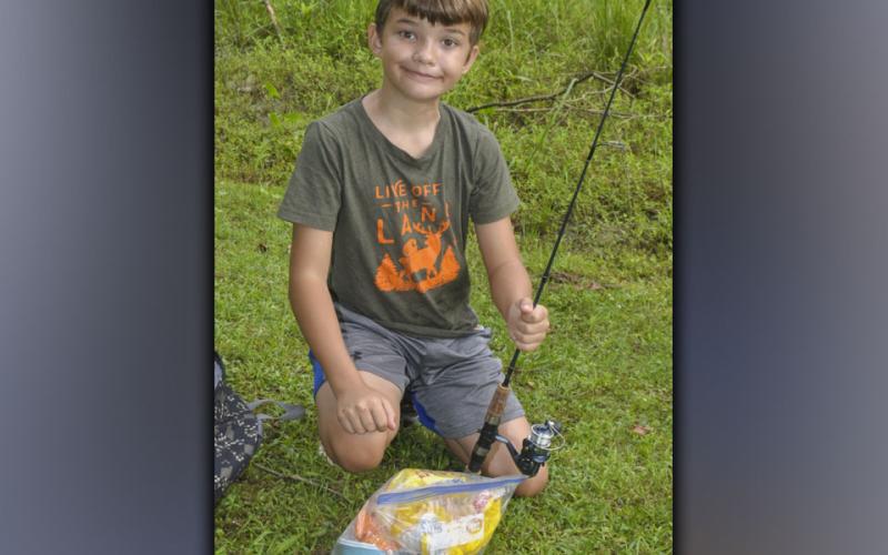 Eddie Marshburn baits his hook and tries to catch a fish during the Fannin County Recreation Department’s fishing camp Wednesday, July 28.