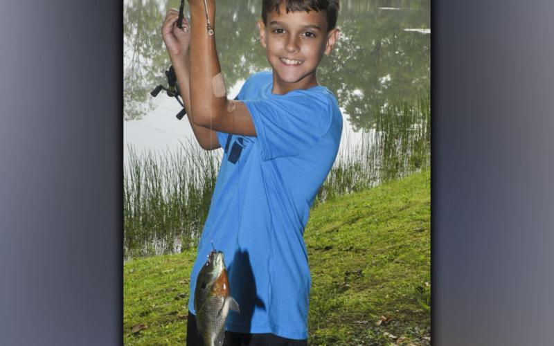 Evander Patterson holds up his monster Bluegill during the fishing camp at Fannin County Recreation Department Wednesday, July 28.