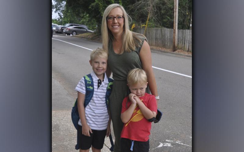 Stopping to pose for a picture on the first day of school at Blue Ridge Elementary School Friday, July 30, are, from left, second grader Tucker Mathews, his mother Beth Mathews, and  younger brother Parker Mathews.