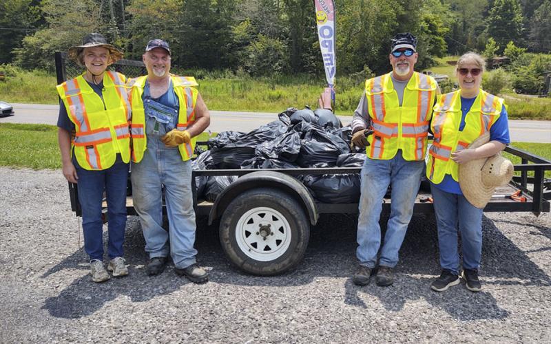 After five hours of cleaning up trash, the four member team collected over 30 bags of trash weighing approximately 750 pounds. Shown are, from left, Patty Freeman, Ronney Freeman, Jeff Thomason and Dee Dee Deal of Turtletown who came together Saturday, July 24, to pick up trash along Runion Road.