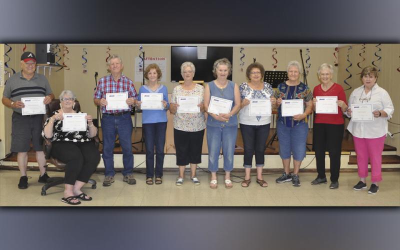 On Friday, August 13, at the Copper Basin Community Center, 10 more Polk County senior citizens graduated after completing 15 hours of computer training. This brings the total to 21 seniors who have completed the training thus far, and each one received a new Chromebook. Shown holding their certificates of completion are, from left, Don Thomas, Barbara Thomas, Wayne Loudermilk, Sarah Loudermilk, Betty Jo Hughes, Beverly Whitmer, Marieda Trammell, Dorothy Jeanette Callihan, Linda Haney and Joyce Reid.
