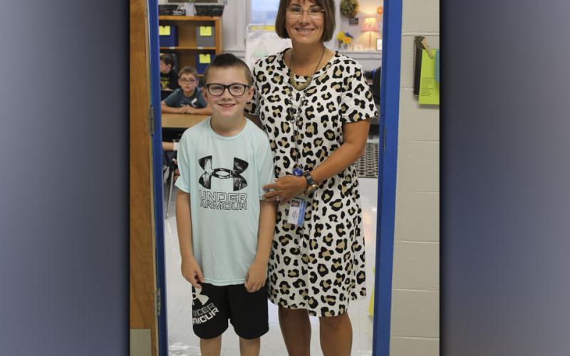 East Fannin Elementary student Zander Sparks, left, smiles on his first day of third grade with his new teacher, Lori Robinson.