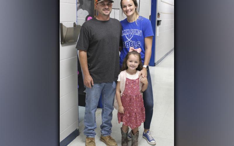 East Fannin Elementary School student Oakleigh Helton poses with her father and mother, Daniel and Heather Helton, as they drop her off for her first day of Kindergarten.