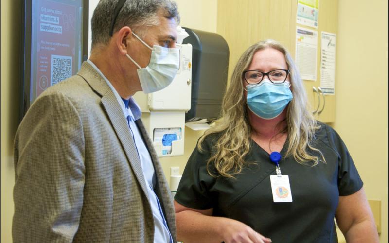 Georgia’s 9th District Congressman Andrew Clyde took time to tour Georgia Mountains Health Monday, August 16, marking it as his first community health center tour. Explaining the operations is Office Manager and Kristie Richardson, RN.