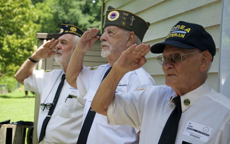 Members of the North Georgia Honor Guard, from left, Steve Strickland, Nick Wimberley and Ed Judge salute the American Flag just before reciting the Pledge of Allegiance during a Flag Etiquette class at Blue Ridge Elementary School Friday, August 27.