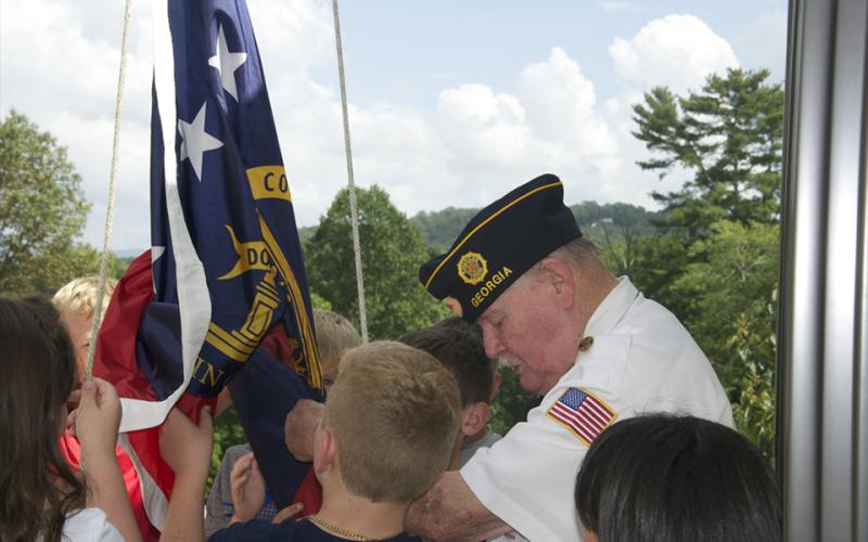 North Georgia Honor Guard member Gerald “Chief Mac” McMillen helps Blue Ridge Elementary School fifth grade students raise the American Flag.