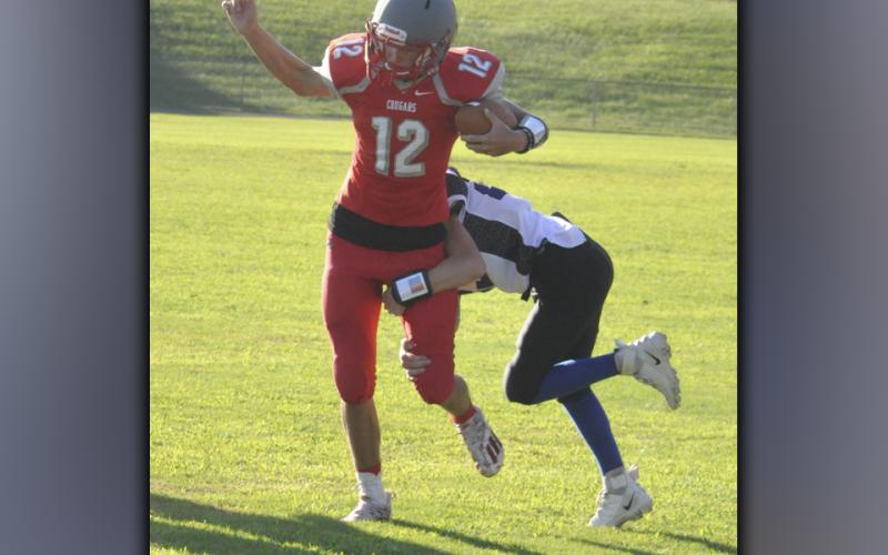 Copper Basin Middle School quarterback Dawson Pittman shakes off a defender during the Cougars game against Bradley County Thursday, September 2.