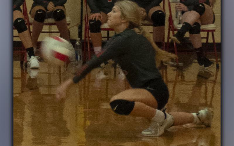 Makenna Miles digs to keep a volley alive in recent action for the Lady Cougar volleyball team.