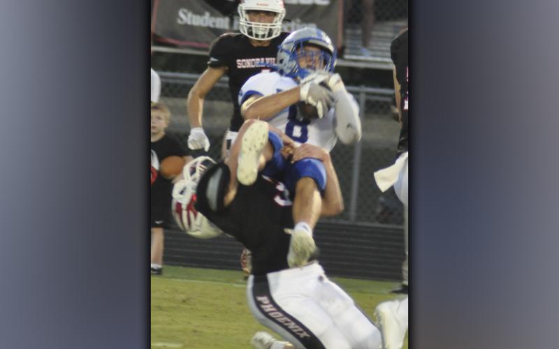 Logan Long (77) muscles his way past a lineman to put pressure on the quarterback during the Rebels game against Sonoraville Friday, September 3.