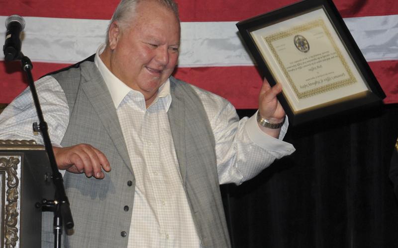 Greg Staffins offers a gesture of appreciation to the crowd after receiving a special Award of Appreciation from the Governor’s Office of Highway Safety at the GOHS Quad Network Banquet in McCaysville last week.