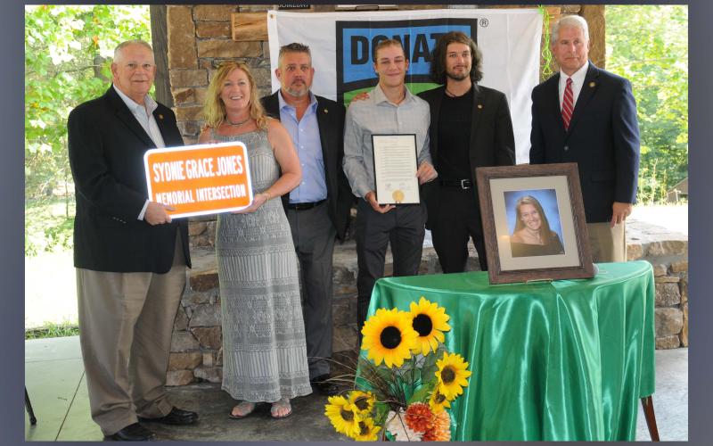 David Ralston, District 7 representative and Speaker of the Georgia House, presented replica signs to Sydnie Grace Jones’ family naming the intersection of Highways 515 and 325 in her honor. Shown, from left, are Ralston, Sydnie’s family, mother Melinda, father Anthony, brothers Andrew and Conner, and Representative Stan Gunter who co-sponsored the resolution naming the intersection.