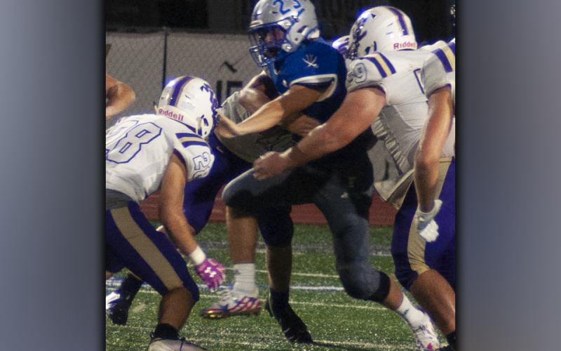 Jackson Davis (23) muscles past Union County defenders during the Rebels football game against Union County Friday, August 20.