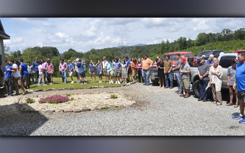 Family, friends and classmates gather outside the Davis’ home Sunday, August 29, for a distanced prayer meeting for Fannin County High School student and athlete Jackson Davis.