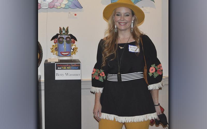 The Blue Ridge Mountains Arts Association held their opening reception for the Contemporary Southern Folk Art exhibit Saturday, September 4. Artist Kristen Ramsey presented her pieces  that are shown hanging on the wall behind her, which she cuts and carves designs out of plywood and paints with enamel.