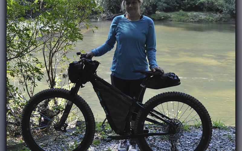 Linda Sledge poses with the bike that she used for the Trans North Georgia (TNGA) bikepacking adventure ride Friday, September 10.