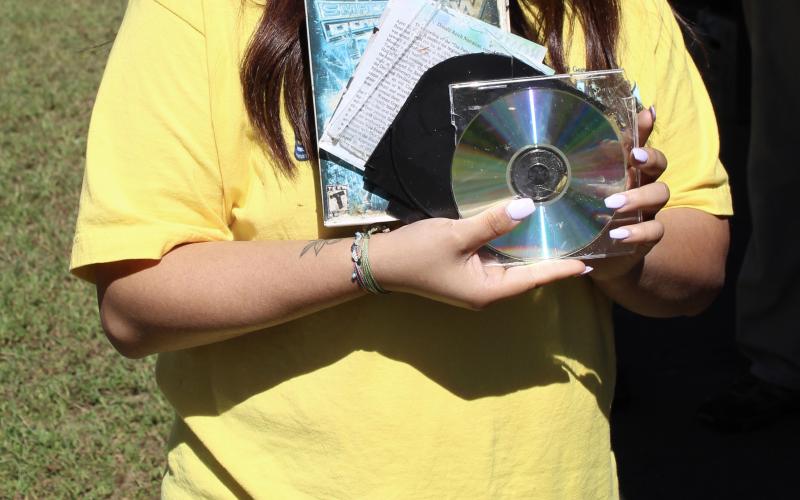 Macy Ruiz, a University of North Georgia student, won the prize for most unusual trash with an old video game and a CD and case found in multiple pieces along the upper section of the Toccoa River.