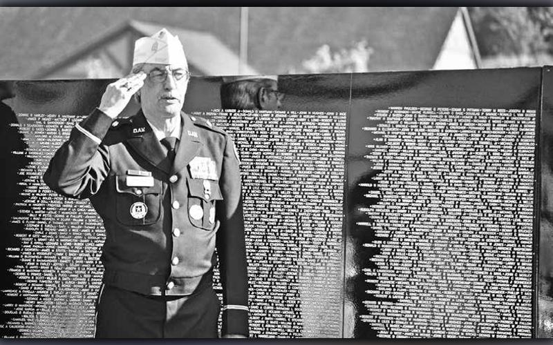 Manny Lozano, retired U.S. Army First Sergeant, salutes the American flag during a presentation of The Vietnam Traveling Memorial Wall that came to Blue Ridge in 2019.