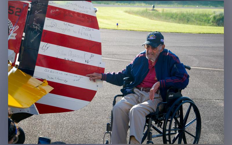 World War II Navy veteran John Ottwell points to his signature on the restored World War II biplane following his flight Tuesday, September 14.