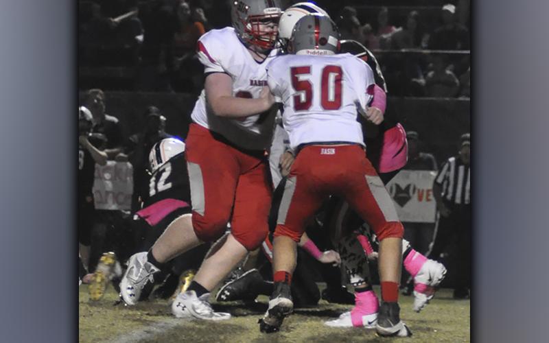 Zach Beach (50) and Tucker Shroth (67) fight to bring down a Tiger ball carrier during the Cougars game against Meigs County Friday, October 8.