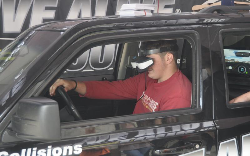 Addison Hook attempts an intoxicated driving simulation during the Arrive Alive Tour at Copper Basin High School Thursday, September 30.