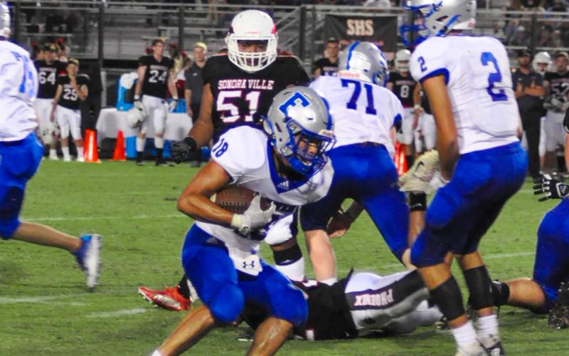 Austin Garland picks up yards for Fannin County as Jeremy Tammen (71) and Hayden Lynch (2) look for blocks. Garland rushed for 48 yards and scored a touchdown against Model last Friday night.