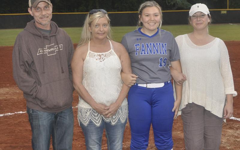 Lady Rebel softball players honored during the last home game of the season Tuesday, October 5. Shown with Davis are, from left, Henry Hall, stepfather; Mitzi Hall, mother; senior Kharcee Hughes and Crystal Campbell, stepmother.