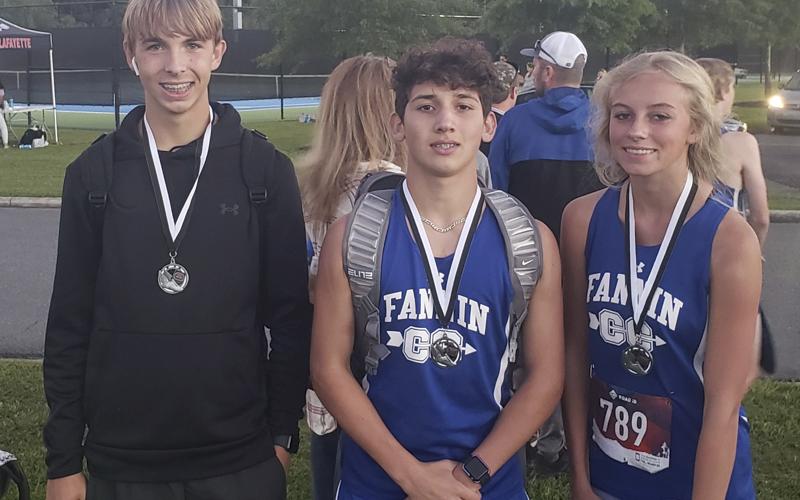 The Fannin County High School cross country team competed in the Wildwood Run at Edwards Park in Dalton, Georgia, Thursday, September 23. Medal winners from the meet include, from left, Gavin Davis, Zechariah Prater and Carlee Holloway.