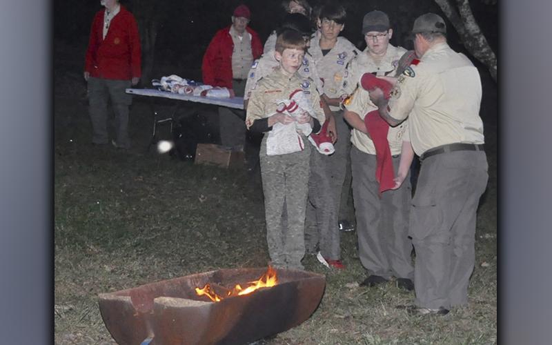 Boy Scouts from Troop 32 from Epworth prepare to place the 13 stripes in the fire that were removed from a U.S. flag they retired during a Flag Retirement Ceremony at Ron Henry Horseshoe Bend Park Tuesday, October 19.