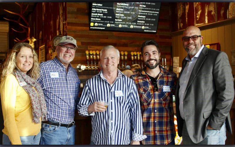 Jahna Allen with ReMax Town &amp; Country, chamber member Mike Wick, Vitor Silva and Steve Tucker with ReMax Town &amp; Country and chamber ambassador Troy Shirbroun pause their conversation for a quick picture at the Fannin County Chamber of Commerce Business After Hours event Tuesday, October 19, at Grumpy Old Men Brewing.