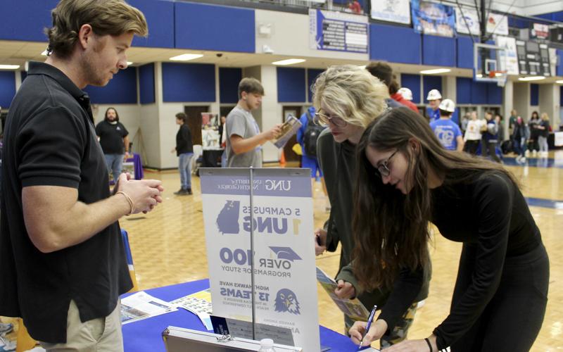 Senior Kenna Verner (left) and junior Hannah Perry (right) asked University of North Georgia Admissions Representative Barrett Rogers questions at the Probe College Fair held at Fannin County High School Friday, October 22. Students were able to speak with representatives from different colleges and universities.