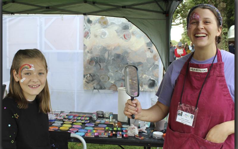 Addy Harvey shows off her face painting by Grace Johnson of Grace’s Painted Faces, Saturday morning at the fall Arts in the Park, October 9.