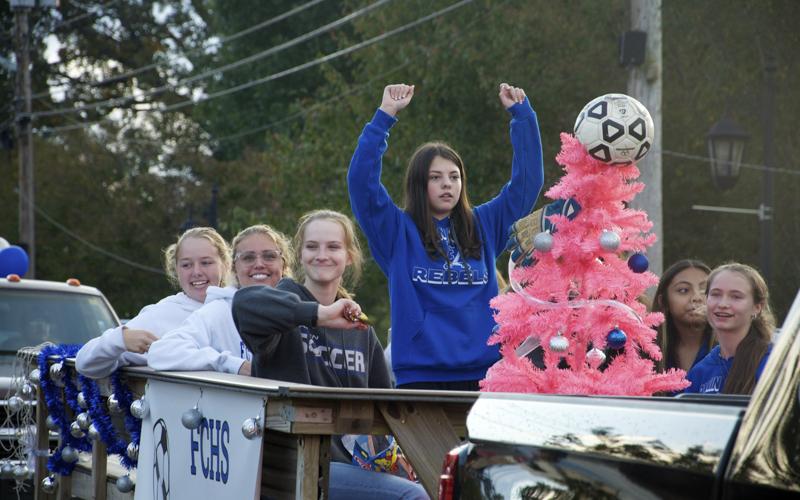 The Fannin County Lady Rebels soccer team hype up the crowd as they make their way along East Main Street in Blue Ridge for a Homecoming Parade Thursday, October 21. On the float are, from left, Annabel Lillard, Kinsley Sullivan, Abby McFarland, Alex Foster, Isobel Espinoza, Karmah Eaton, and, behind the tree, Ashley Campuzano.