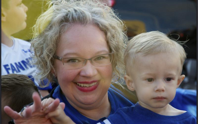 East Fannin Elementary School Assistant Principal Andrea Crump holds grandson Riley Davis while they show their Rebel pride during a Homecoming Parade Thursday, October 21.