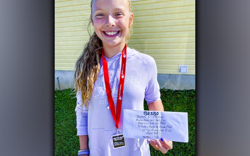 Brooklyn Owenby holds up her winnings after placing fourth in the Bottom 8 Bracket of the Blue Ridge Soap Box Derby that took place Saturday, September 25.