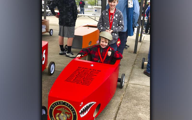 Gideon and Maxwell Scott prepare to race their Lake Blue Ridge Marine Corps League Detachment #1438 car in the Blue Ridge Soap Box Derby Fall Classic. The two each placed within the Bottom 8 Bracket of the race.