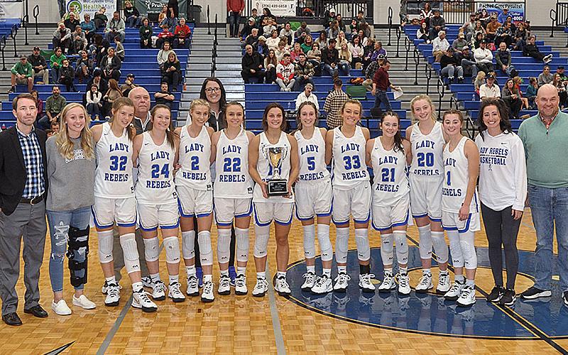The Fannin County Lady Rebels were crowned ETC Tournamnet champions Tuesday, November 23, after their 42-39 victory against the Pickens County Dragonettes. Shown following the victory are, from left, front, Coach Ryan Chastain, Nicole Pittman, Macy Hawkins Jayden Bailey, Ellie Cook, Riley Reeves, Becca Ledford, Reigan O’Neal, Reagan York, Jenna Young, Ava Queen,Courtney Davis, Lacey Walden and ETC Chief Operating Officer Jason Smith; and back, coaches Randy Hallmark and Megan Orton.