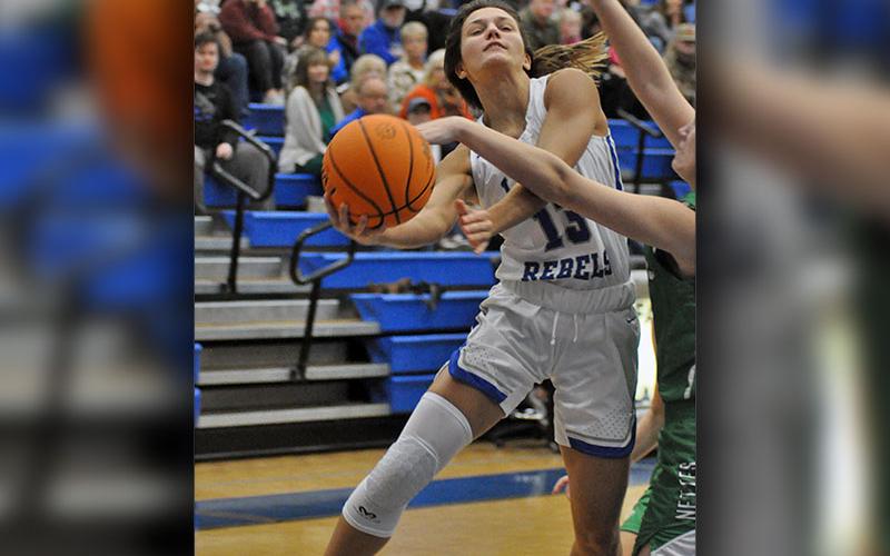 Lady Rebel Becca Ledford fights through contact for a two-point basket during the Lady Rebels basketball game against Gilmer County Monday, November 22.
