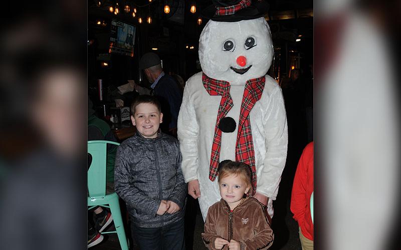 Frosty the Snowman put smiles on the faces of Robert Cole and Elizabeth Cole while they waited for the Christmas tree lighting in McCaysville.