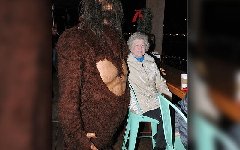 Betty Helton got a surprise visit from Big Foot while she waited for the Christmas tree lighting from the deck outside Burra Burra on the River.