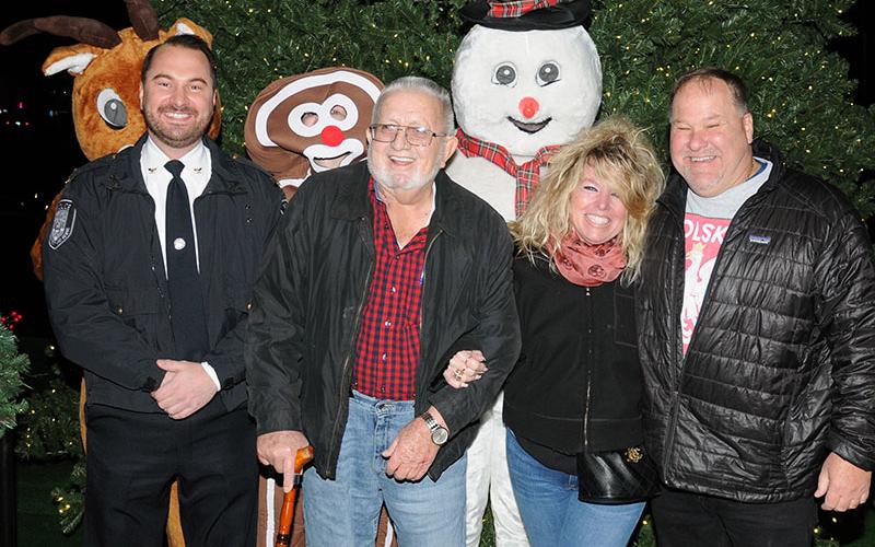 “River Friday” kicked off the Christmas season in McCaysville Friday, November 26. Following the lighting of the Christmas tree, from left, McCaysville Police Chief Michael Earley, Mayor Thomas Seabolt, and Barbara and Mike Galinski were all smiles. The tree lighting was sponsored by the McCaysville Business Association.