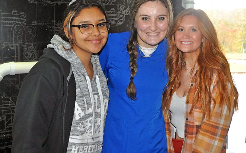 After successfully completing the plumbing challenge Thursday, November 4, Fannin County High School students, from left, Lizabeth Acevedo, Erin Gonzales and Olivia McAllister are all smiles.