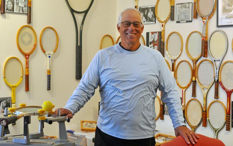 Standing inside his vintage tennis museum, Mountain Tennis, Mel Locklear enjoys spending his retirement time not only educating the community about the history and game of tennis, but also volunteering his time giving free tennis lessons to local area kids in the Blue Ridge City Park Monday through Thursday afternoons, 50 weeks out of the year.