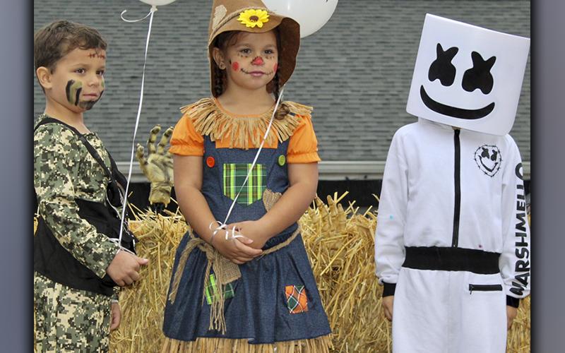 Roman Hayes as a G.I. Joe, McKayla Hayes as a scarecrow and Jacob Jones as Marshmello stand on stage for the Blue Ridge Business Association’s costume contest at the Halloween Safe Zone Saturday, October 30.