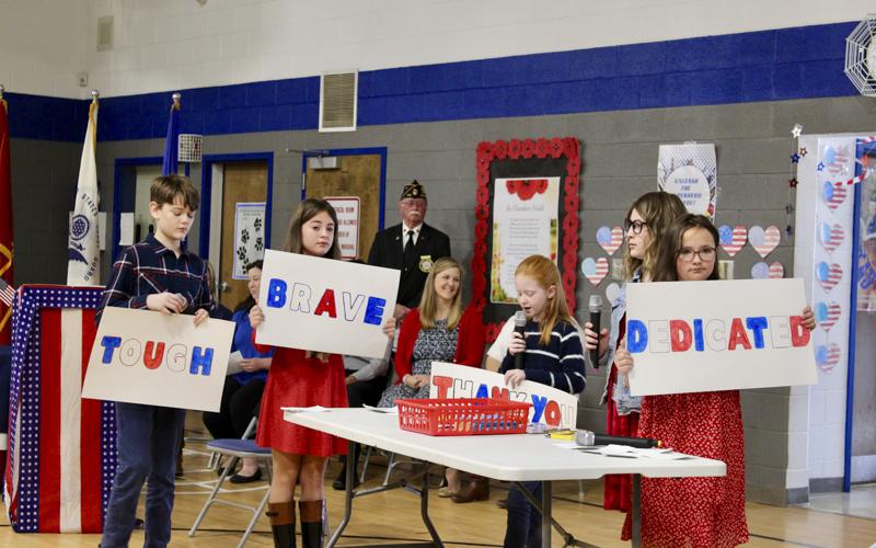 Blue Ridge Elementary School fifth grade students asked the question “What is a Veteran?” in their skit during the Veterans Day Ceremony November 10. Shown are, from left, Branson Ross, Olivia Hill, Aubrey Barton, Addyson Bradburn and Ruby Curtis as North Georgia Honor Guard Commander Bill Stodghill watches in the back.